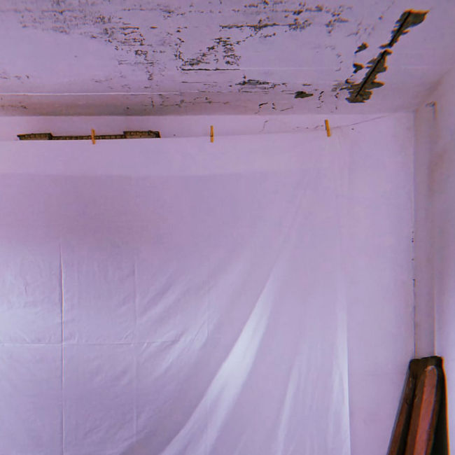 White sheet used as a video projection surface during an artist residency installation. White sheet used as a video projection surface during an artist residency installation.